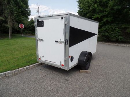 Used 2025 ALCOM 5' by 10 ft. , with 2,990 lb. GVWR, 67" interior height Cargo / Enclosed Trailer