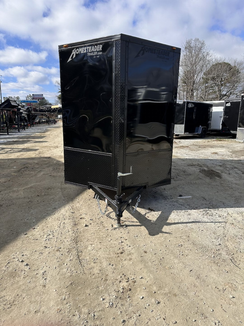New 2025 HOMESTEADER TRAILER / INTREPID SERIES / 6' WIDE X 12' LONG / 6'6" INTERIOR HEIGHT / BLACK .030 ALUMINUM W/ BLACK OUT PKG / 32" SIDE DOOR W/ RV LOCK / RAMP REAR DOOR / 4-D RINGS / 16" O/C WALL POST