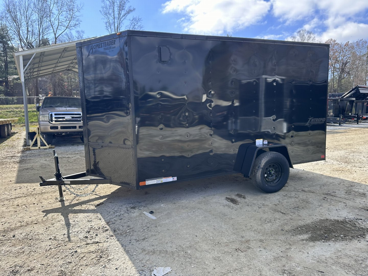 New 2025 HOMESTEADER TRAILER / INTREPID SERIES / 6' WIDE X 12' LONG / 6'6" INTERIOR HEIGHT / BLACK .030 ALUMINUM W/ BLACK OUT PKG / 32" SIDE DOOR W/ RV LOCK / RAMP REAR DOOR / 4-D RINGS / 16" O/C WALL POST