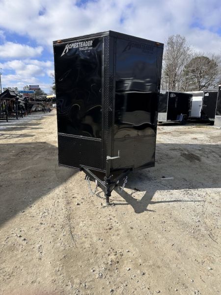 New 2025 HOMESTEADER TRAILER / INTREPID SERIES / 6' WIDE X 12' LONG / 6'6" INTERIOR HEIGHT / BLACK .030 ALUMINUM W/ BLACK OUT PKG / 32" SIDE DOOR W/ RV LOCK / RAMP REAR DOOR / 4-D RINGS / 16" O/C WALL POST