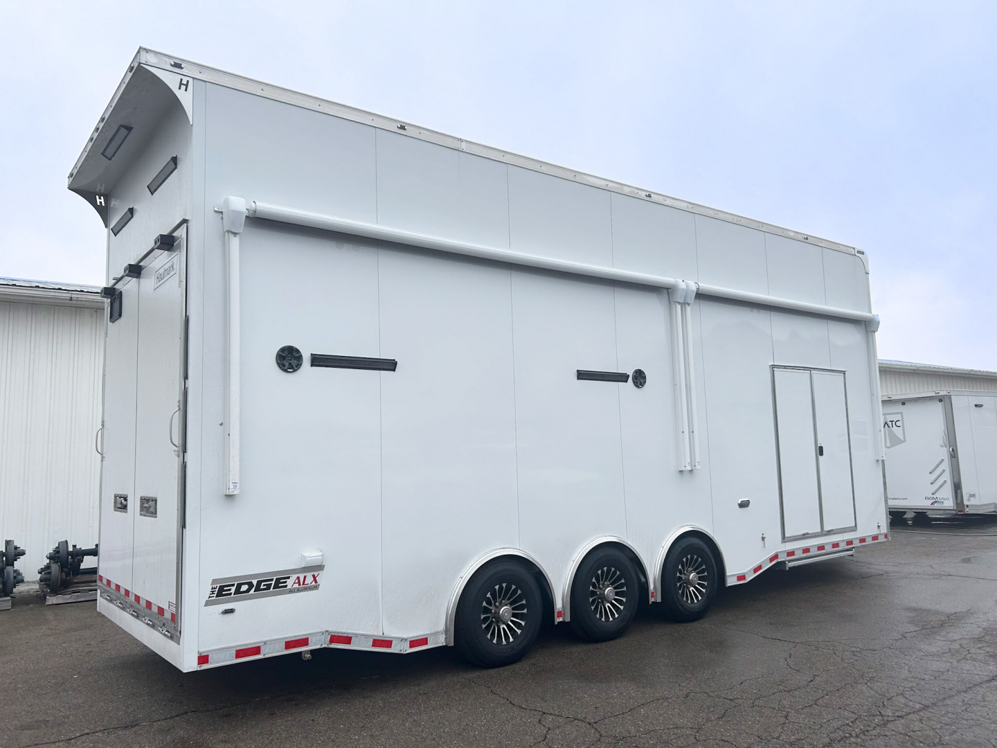 New 2026 Haulmark 28 FT EDGE ALUMINUM STACKER TRAILER W/ ESCAPE DOOR AND AWNINGS